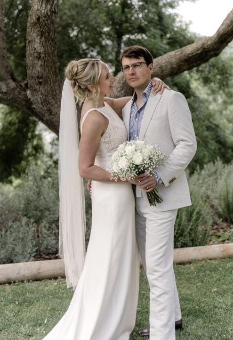 Bride and groom under an olive tree
