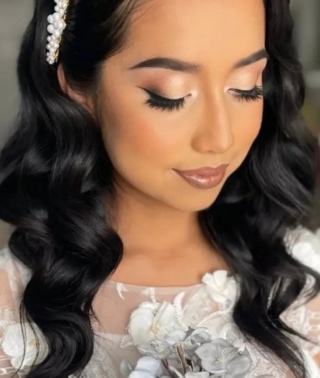 Bride with soft glam waves and a pearl hair clip