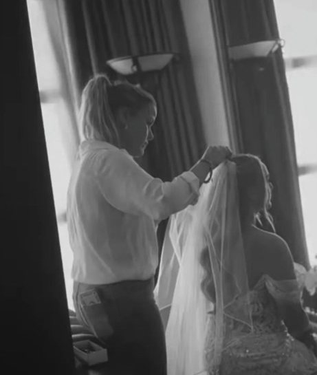 Louise placing a bride's veil